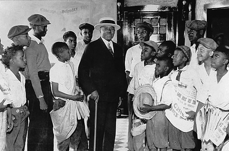 Chicago Defender Founder and Publisher Robert S. Abbott surrounded by newsboys in an undated photo from the 1920s. (Courtesy of the Chicago Defender Charities) 